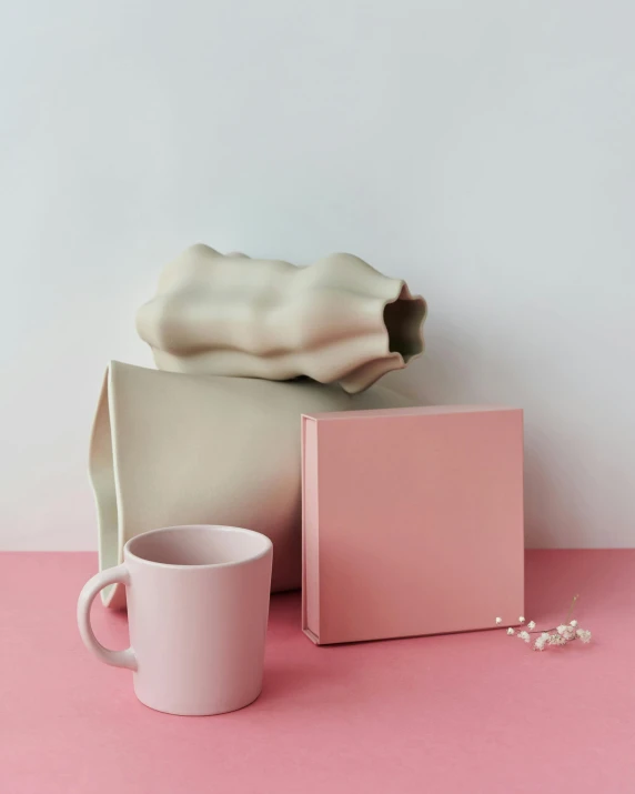 a bag and a cup on a pink surface, inspired by Sarah Lucas, happening, soft white rubber, professional product photo, grey, cream paper