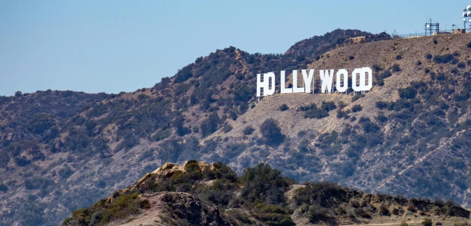 a large hollywood sign on top of a mountain, billboard image, wolff olins |, large format, trending photo