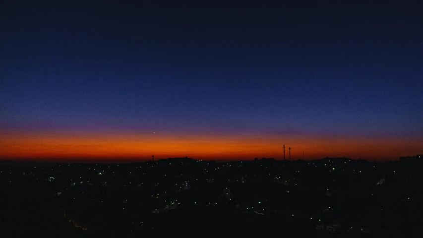 a view of a city at night from the top of a hill, a picture, by Attila Meszlenyi, sunset on mars, gradation, blue sunset, 2022 photograph