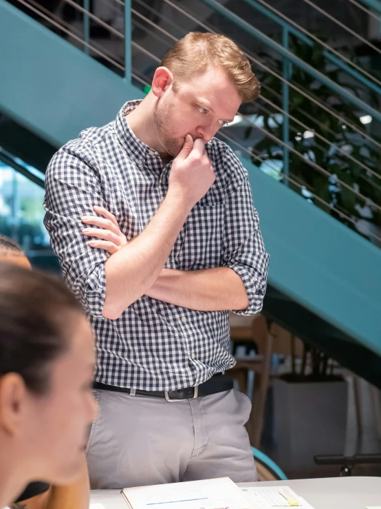 a man standing next to a woman at a table, pexels contest winner, happening, looking exhausted, wearing stripe shirt, linus from linustechtips, profile image