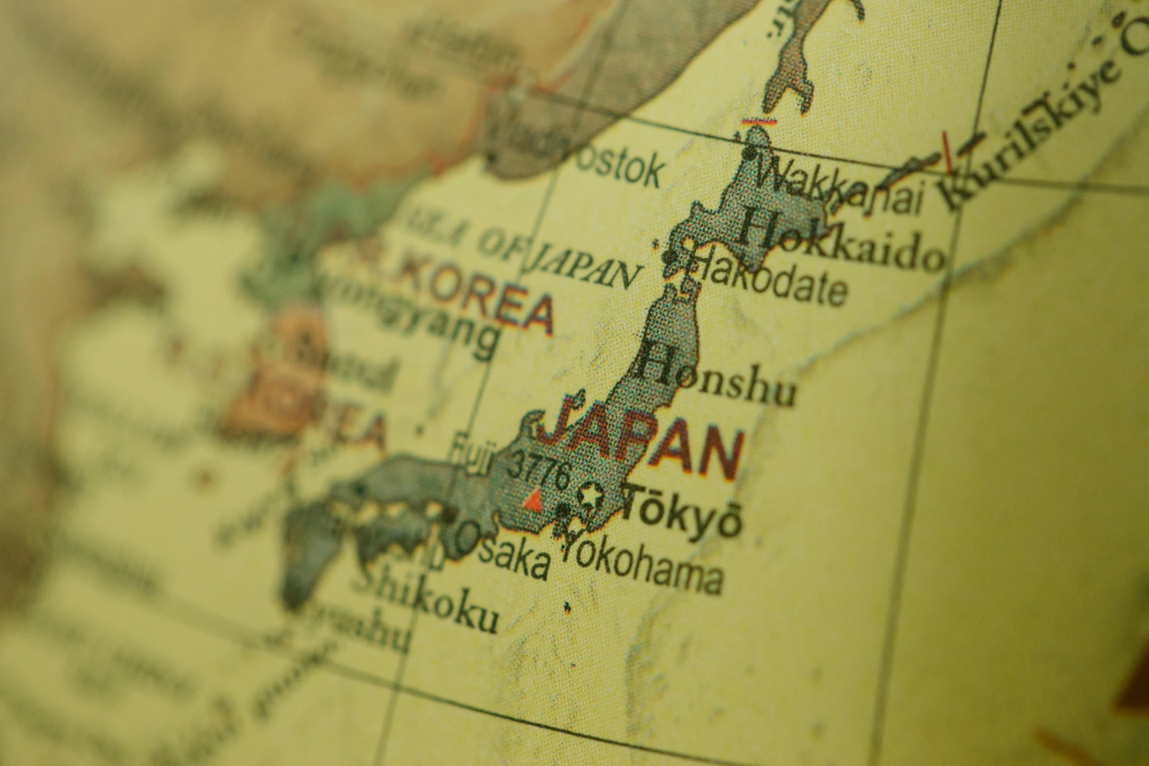 a close up of a map of japan, unsplash, slide show, brown, north korea, government archive photograph