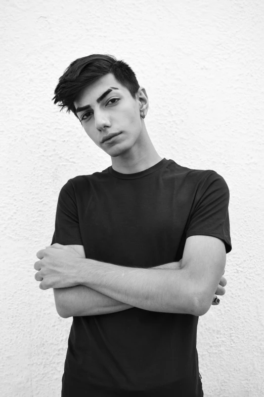 a black and white photo of a man with his arms crossed, inspired by Luca Zontini, tumblr, antipodeans, wearing a black shirt, bella poarch, young anime man, 'white background'!!!