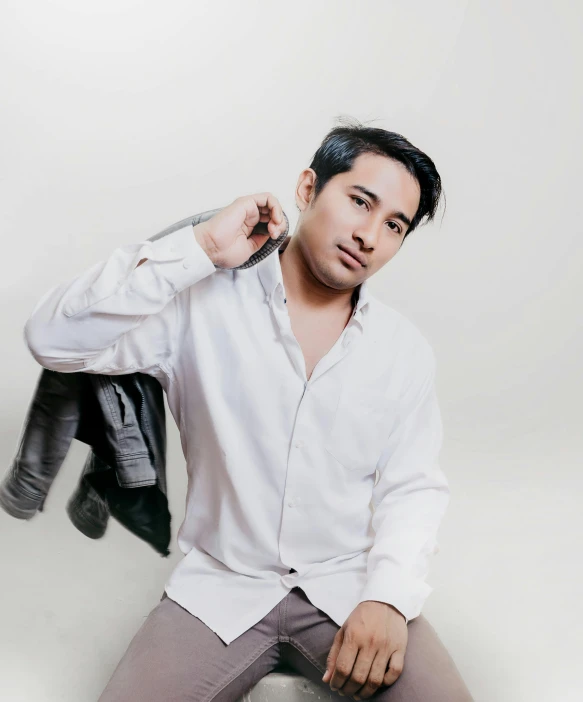 a man in a white shirt and gray pants, an album cover, inspired by Pablo Carpio, unsplash, headshot photo, sholim, glamour shot, trending photo