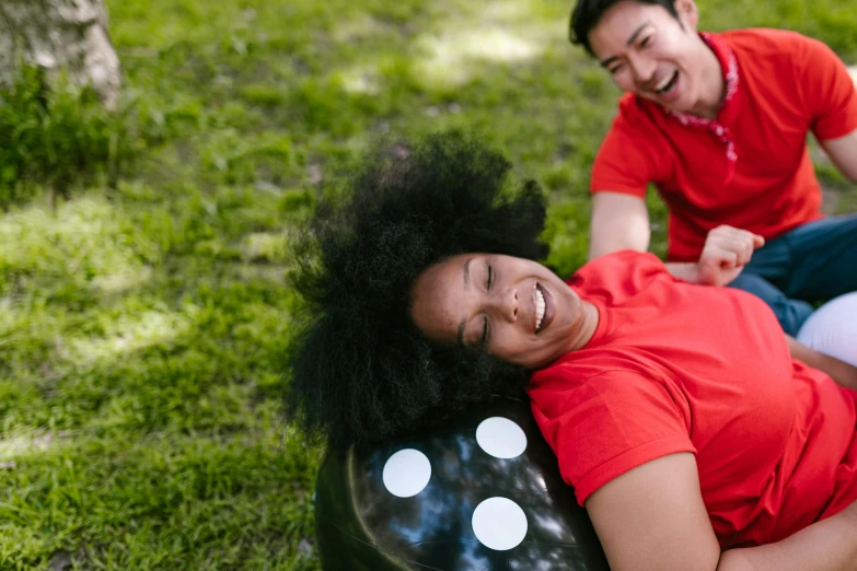 a couple of people that are laying down in the grass, hypersphere, smiling playfully, ying and yang, mixed race