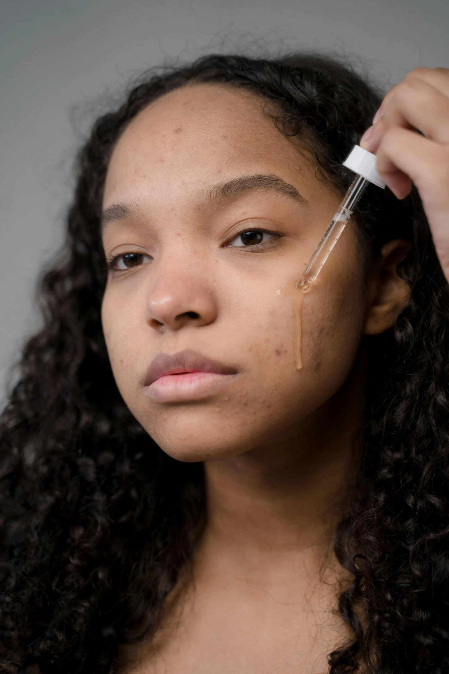 a woman brushing her hair with a brush, an album cover, trending on pexels, renaissance, trypophobia acne face, brown skin. light makeup, face with scars, teenage girl