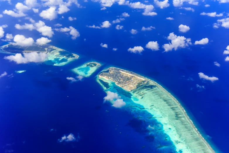 an aerial view of an island in the middle of the ocean, by Matthias Stom, pexels contest winner, hurufiyya, foster and partners, maldives in background, thumbnail, rectangle