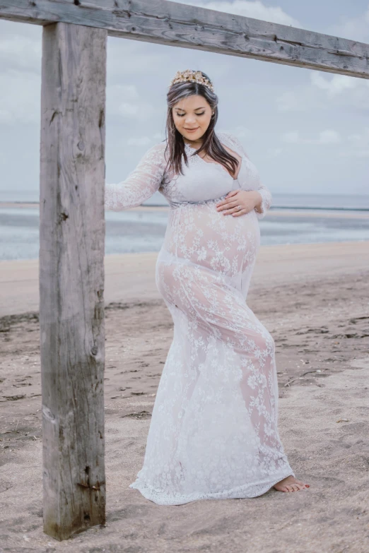 a pregnant woman standing under a wooden structure on the beach, inspired by Christen Købke, baroque, fine lace, 3 / 4 pose, clear curvy details, jacqueline e