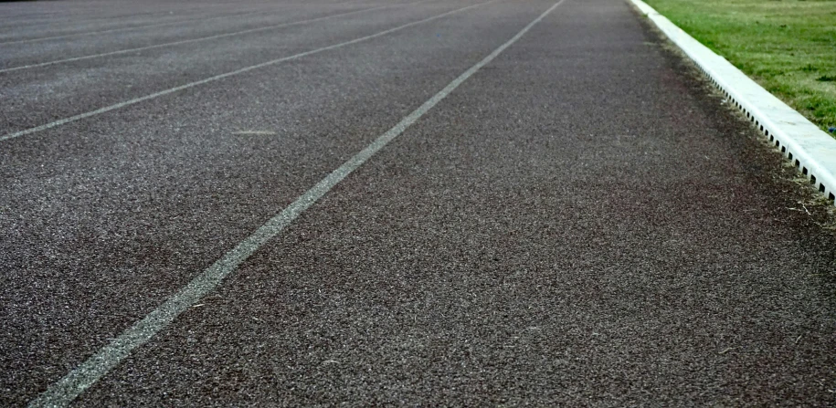 a red fire hydrant sitting on the side of a road, by Anna Findlay, pexels, postminimalism, sprinters in a race, dark grey carpet, on a racetrack, thin straight lines