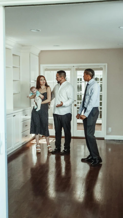 a group of people standing in a room, real estate photography, pregnancy, getty images, square