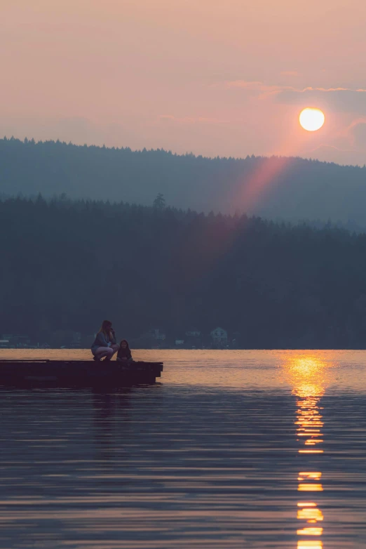 a person in a boat on a lake at sunset, british columbia, very smoky, two suns are in the sky, sitting down