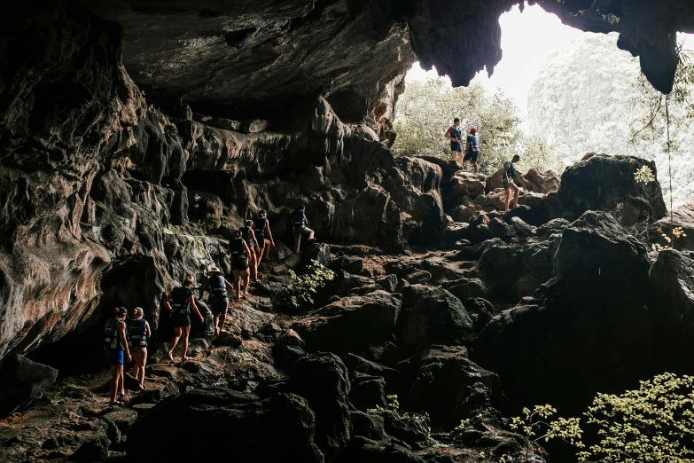 a group of people standing inside of a cave, trecking, avatar image