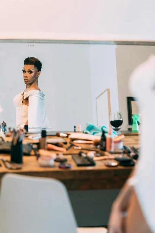 a man that is standing in front of a mirror, trending on pexels, ru paul\'s drag race, african american woman, on a white table, evening makeup