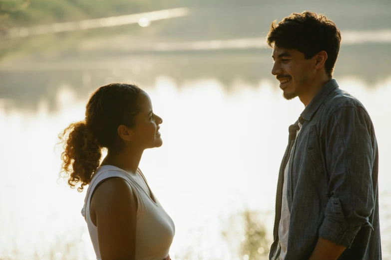 a man and a woman standing next to each other, happening, golden hour scene, mark edward fischbach, smiling at each other, hispanic