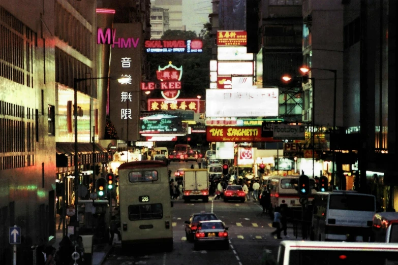 a city street filled with lots of traffic next to tall buildings, inspired by Thomas Struth, 8 0 s asian neon movie still, advertising photo, vhs colour photography, 2000s photo