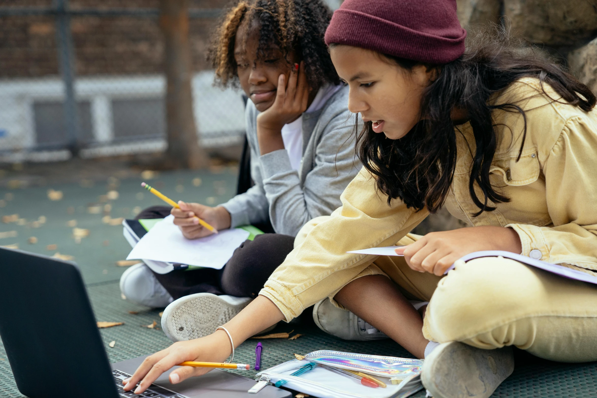 two girls sitting on the ground looking at a laptop, a child's drawing, pexels contest winner, academic art, willow smith zendaya, writing on a clipboard, low angle shot, 15081959 21121991 01012000 4k