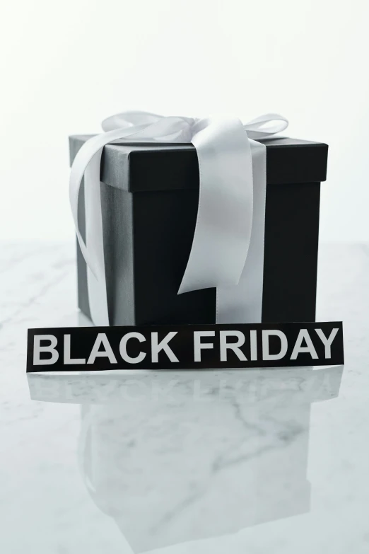 a black friday gift sitting on top of a table, by Adam Saks, white, one, panel of black, no cropping