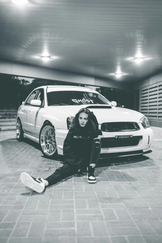 a woman sitting on the ground next to a car, inspired by Károly Brocky, unsplash, hurufiyya, rapper, in a menacing pose, indoor picture, profile image