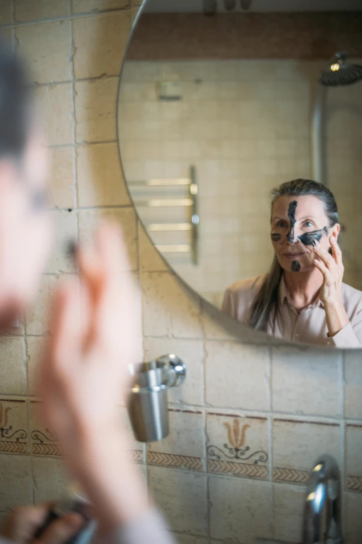 a man shaving his face in front of a mirror, a portrait, by Jan Tengnagel, shutterstock, wearing an eye patch, older woman, in bathroom, rotting black clay skin