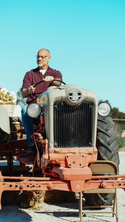 a man sitting on top of a tractor, by Amos Ferguson, pexels, renaissance, a bald, an olive skinned, promo still, american gothic style