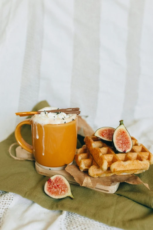 a cup of coffee and waffles on a table, a still life, inspired by Muggur, trending on pexels, hurufiyya, white and orange, square, juice, golden