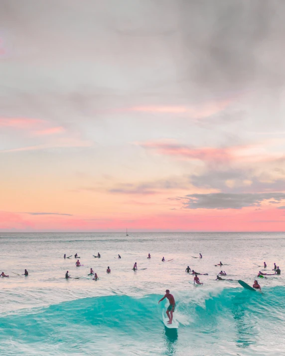 a group of people riding surfboards on top of a wave, pink skies, white beaches, body of water