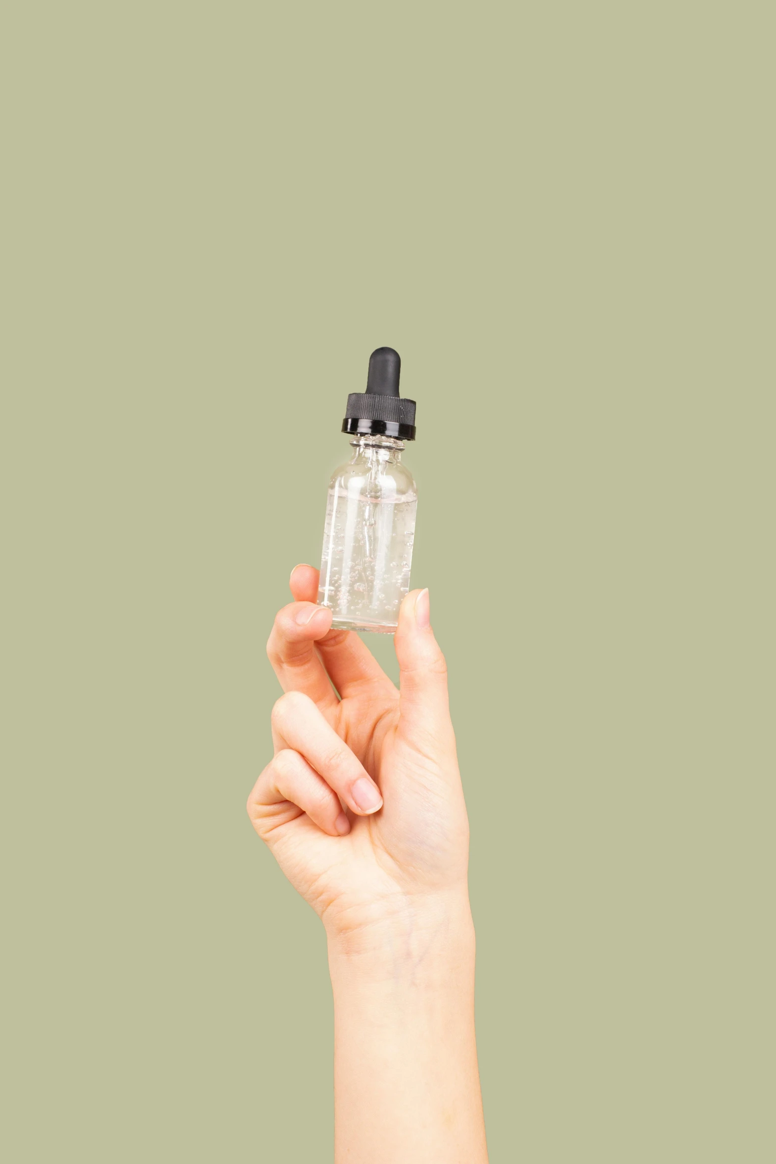 a person holding a bottle of liquid in their hand, by Rachel Reckitt, thc, on a pale background, easy to use, edible