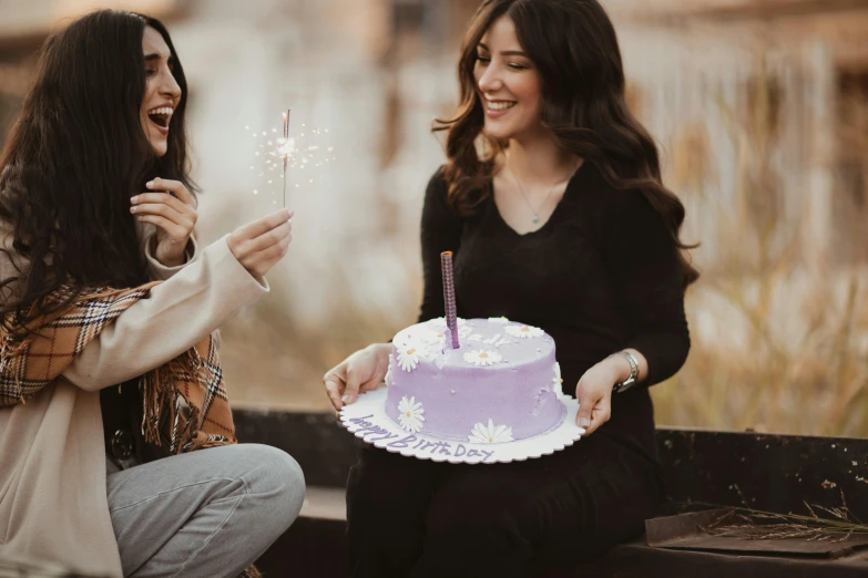 a couple of women sitting next to a cake, pexels contest winner, happy birthday, ((purple)), brunettes, holding a wand