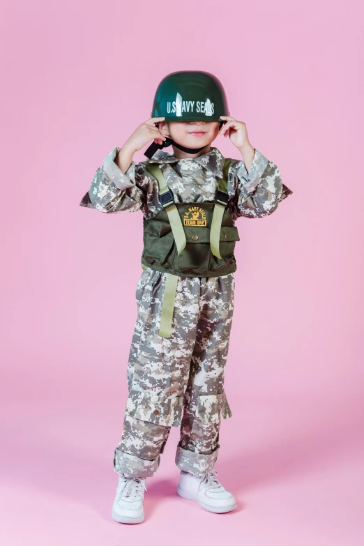 a little boy dressed up as a soldier, an album cover, unsplash, dau-al-set, biopunk toys made in china, on clear background, tactical squad :9, costume