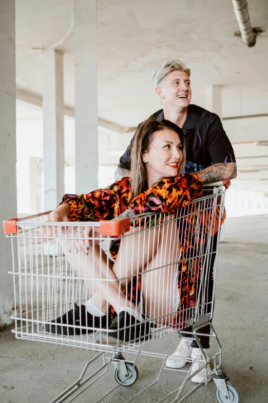 a man and a woman sitting in a shopping cart, by Julia Pishtar, happening, lynn skordal, heath clifford, mr beast, body shot