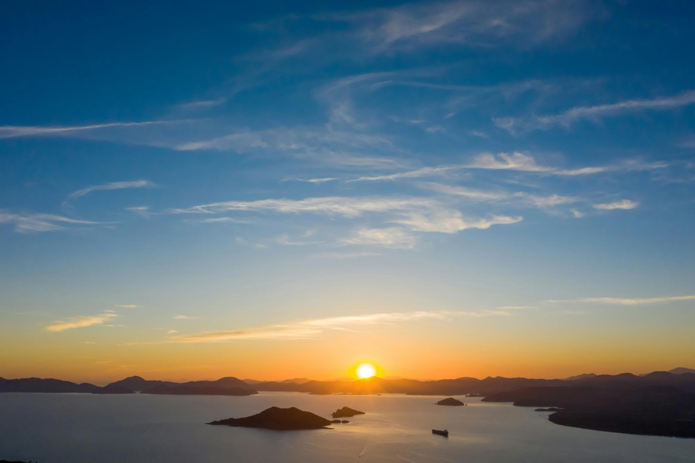 the sun is setting over a large body of water, by Tobias Stimmer, pexels contest winner, islands on horizon, birdseye view, te pae, thumbnail