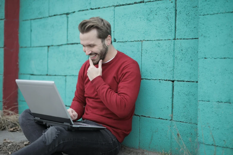 a man sitting on the ground using a laptop, pexels contest winner, sarcastic smiling, slightly red, 15081959 21121991 01012000 4k, flirting