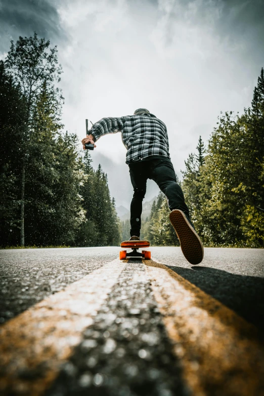 a man riding a skateboard down the middle of a road, by Tom Bonson, unsplash contest winner, lumberjack, profile picture, ::