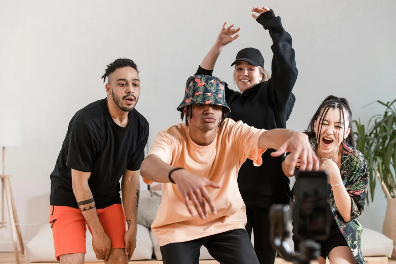 a group of people standing on top of a wooden floor, a cartoon, trending on pexels, happening, with rap cap on head, actors, practice, te pae
