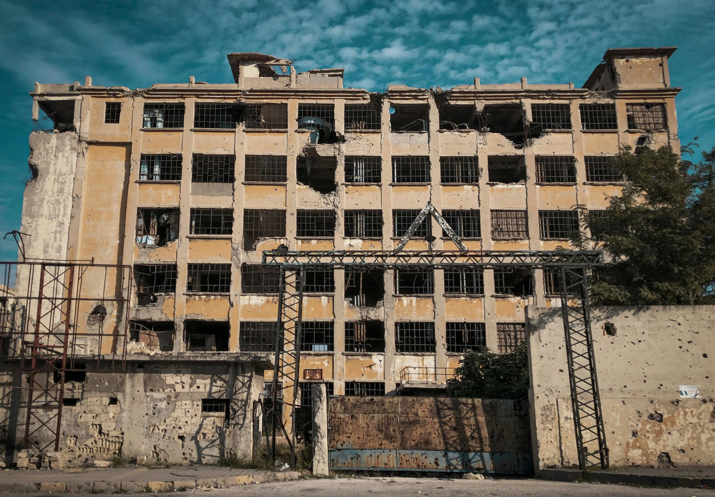 an old building with a bunch of windows, an album cover, by Arthur Sarkissian, pexels contest winner, destruction, factory, naples, photo taken from the ground