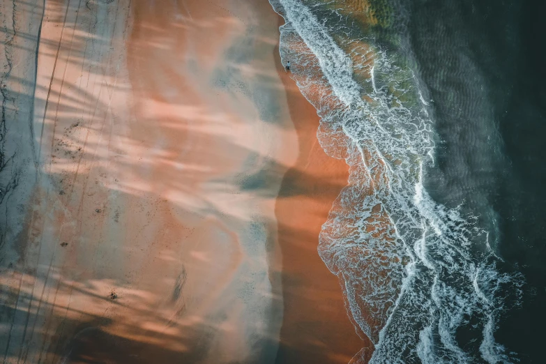 a large body of water next to a sandy beach, by Adam Marczyński, unsplash contest winner, generative art, flowing salmon-colored silk, bird\'s eye view, light and dark, oceanside