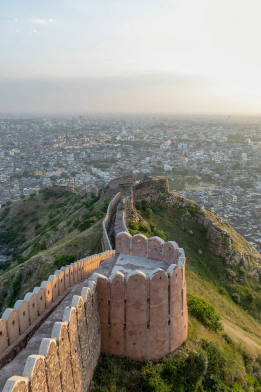 a view of the city from the top of a hill, mogul khan, giant castle walls, taken at golden hour, dan mumfor