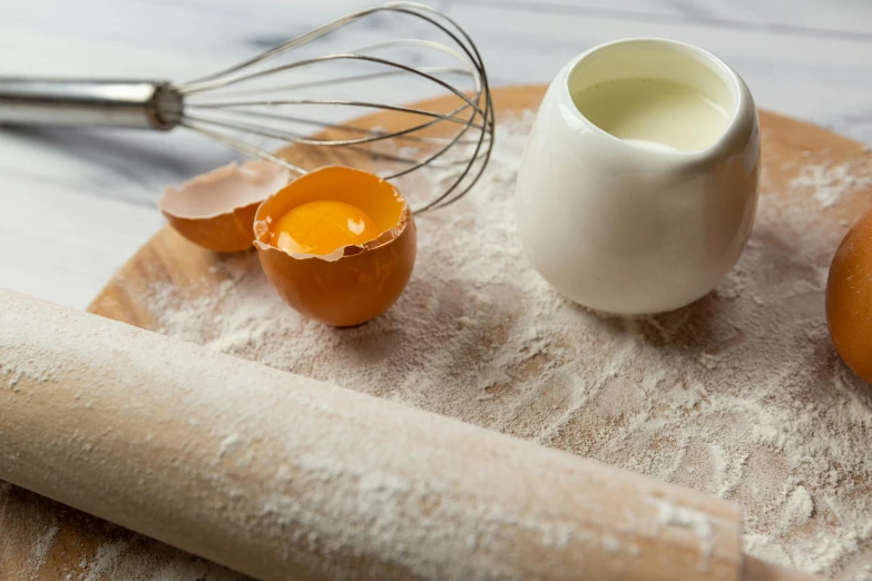 a rolling pin sitting on top of a wooden cutting board, a still life, trending on pexels, eggs benedict cumberbatch, covered in white flour, white ceramic shapes, coast