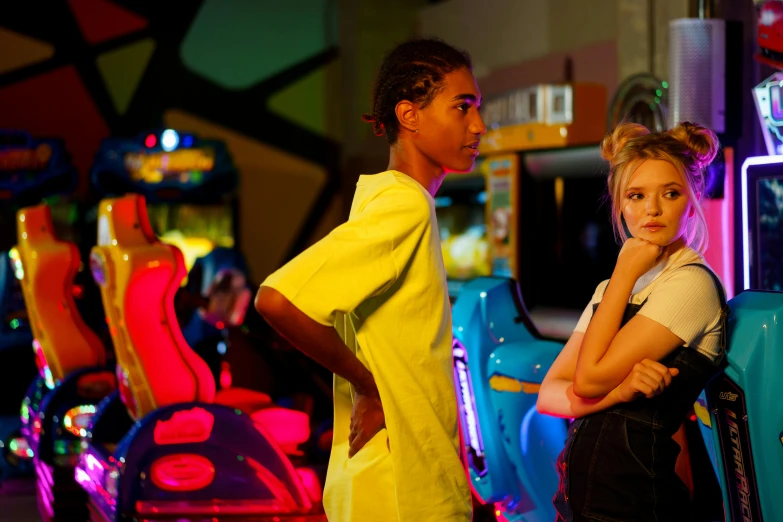 a couple of girls standing next to each other, by Lee Loughridge, pexels, happening, a busy arcade, scene from the film, looking to his left, neon jungle