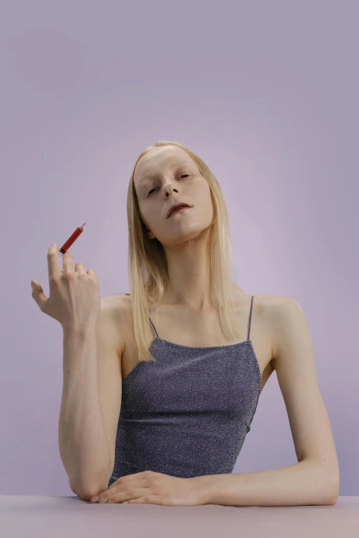 a woman sitting at a table with a cigarette in her hand, an album cover, by Eva Frankfurther, trending on pexels, hyperrealism, albino skin, purple and red, tall and lanky skinny, offering the viewer a pill