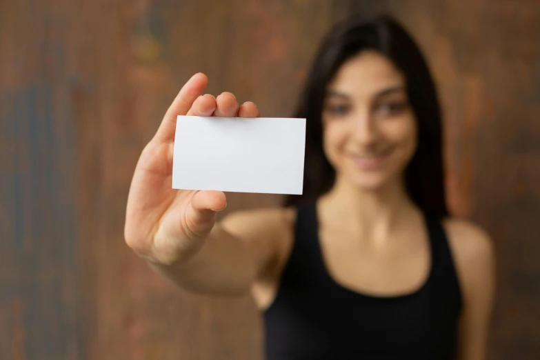 a woman holding a business card in her hand, pexels contest winner, private press, square, fit girl, made of lab tissue, no - text no - logo