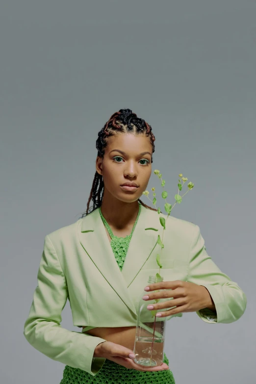 a woman in a green suit holding a glass, an album cover, by Morris Kestelman, cornrows, branches sprouting from her head, 1997 ), close - up portrait shot