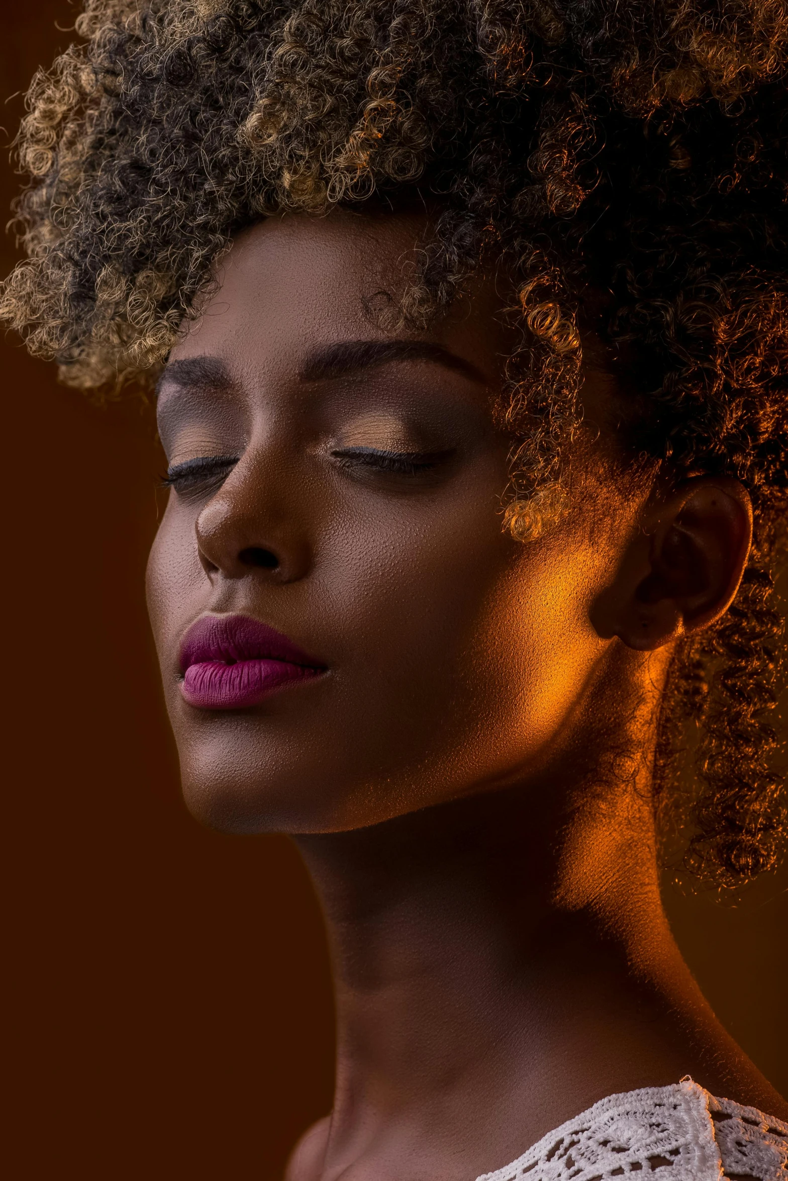 a close up of a woman with her eyes closed, trending on pexels, afrofuturism, studio lighting”, golden glow, short blonde afro, ( ( dark skin ) )