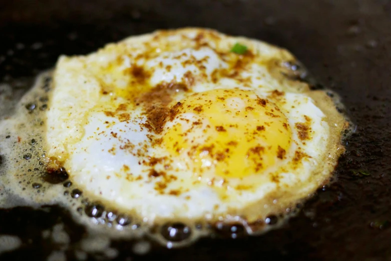 a fried egg is cooking in a frying pan, by Joe Bowler, hurufiyya, fan favorite, sri lanka, close up of iwakura lain, recipe