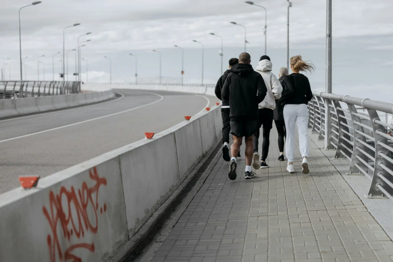 a group of people walking across a bridge, by Christen Dalsgaard, pexels contest winner, happening, workout, on the concrete ground, 15081959 21121991 01012000 4k, norilsk