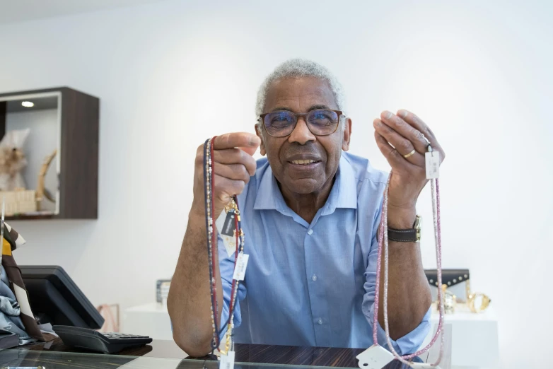 a man sitting at a desk with a tie around his neck, inspired by Ismail Gulgee, process art, revealing wires and electronics, he is about 7 0 years old, 3 meters, dentist