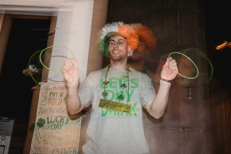 a man with an orange wig holding two hula hoops, a photo, pexels contest winner, four leaf clover, college party, wearing greek palla, conor walton