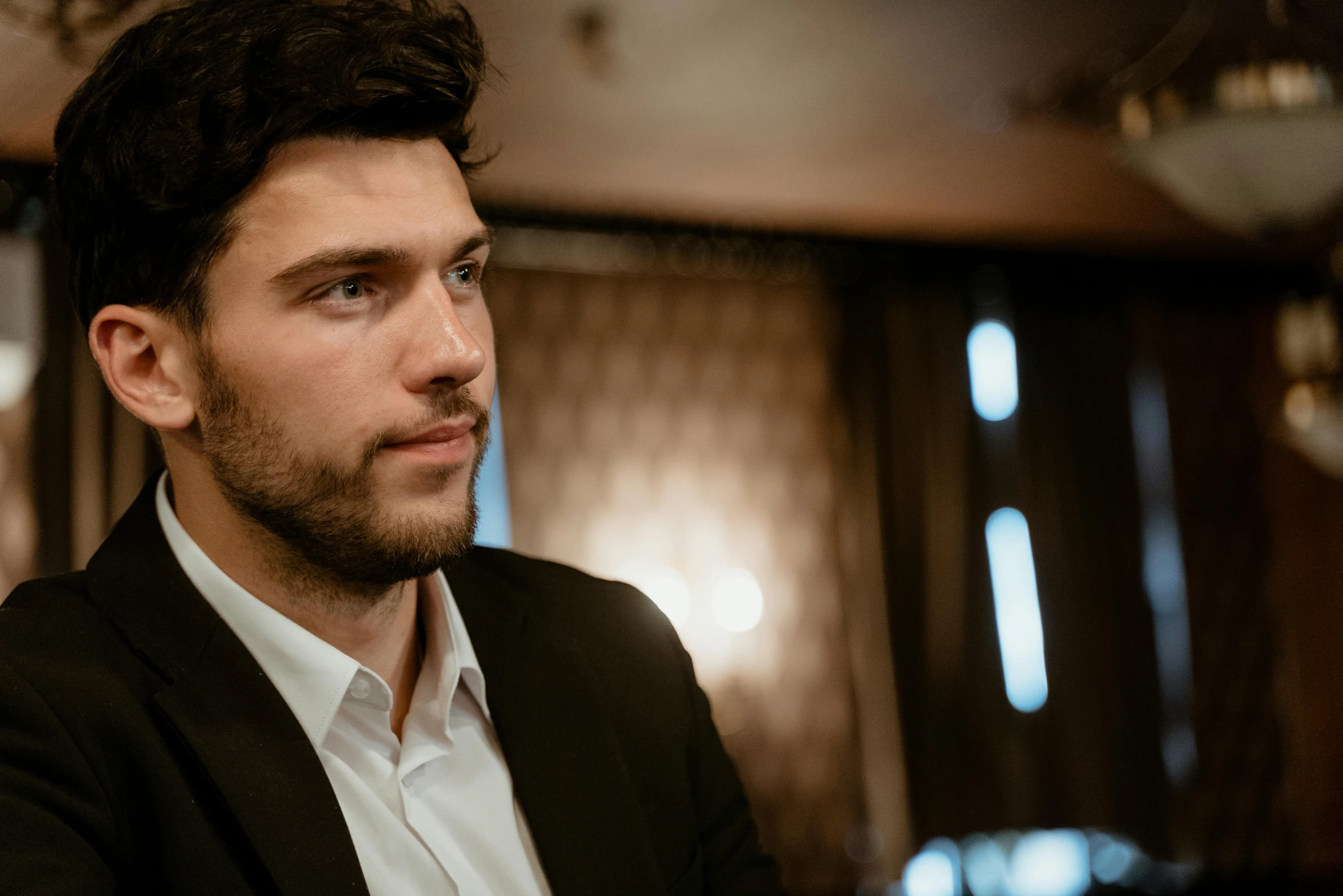 a close up of a person wearing a suit, by Daniel Seghers, pexels contest winner, photorealism, attractive man playing piano, magnus carlsen, distant thoughtful look, thumbnail