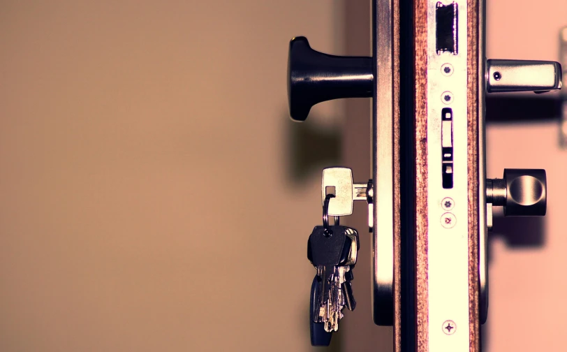 a close up of a door handle with a bunch of keys, a digital rendering, unsplash, square, background image, lo-fi, brown