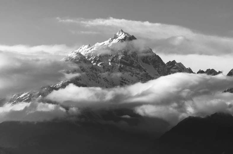 a black and white photo of a snow covered mountain, pexels contest winner, on clouds, nepal, july 2 0 1 1, medium poly