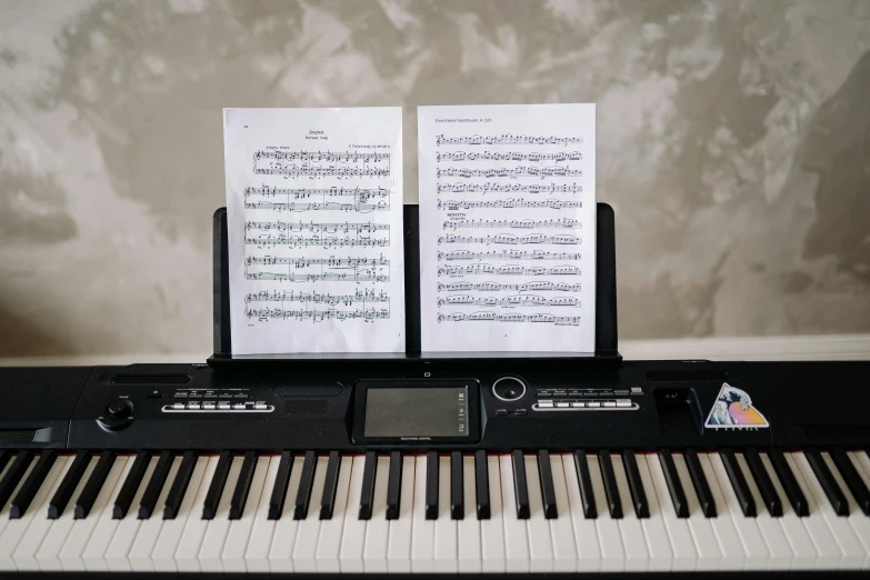 a piano with sheet music sitting on top of it, unsplash, sōsaku hanga, fully frontal view, high quality photo, using synthesizer, photograph taken in 2 0 2 0